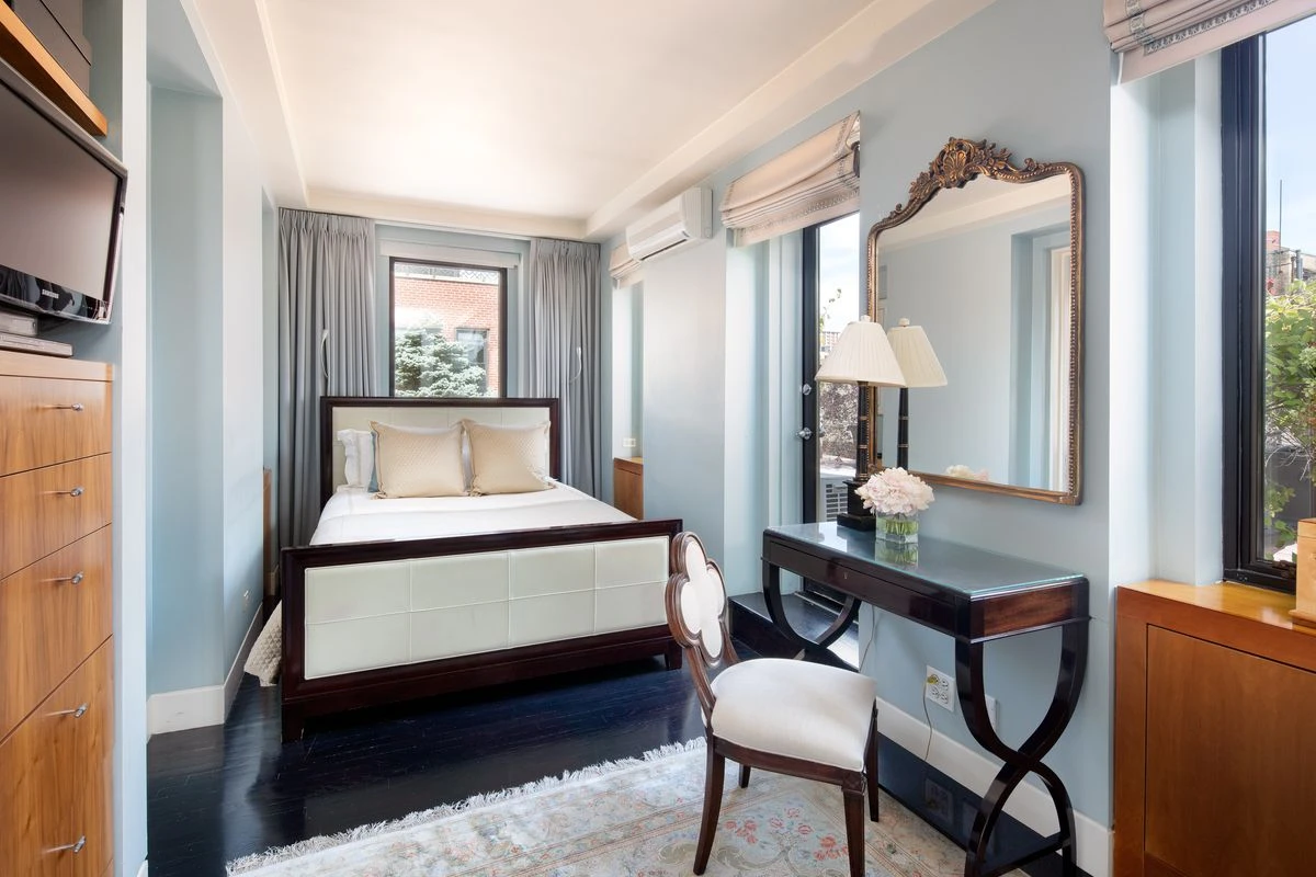 A bedroom surrounded by windows.